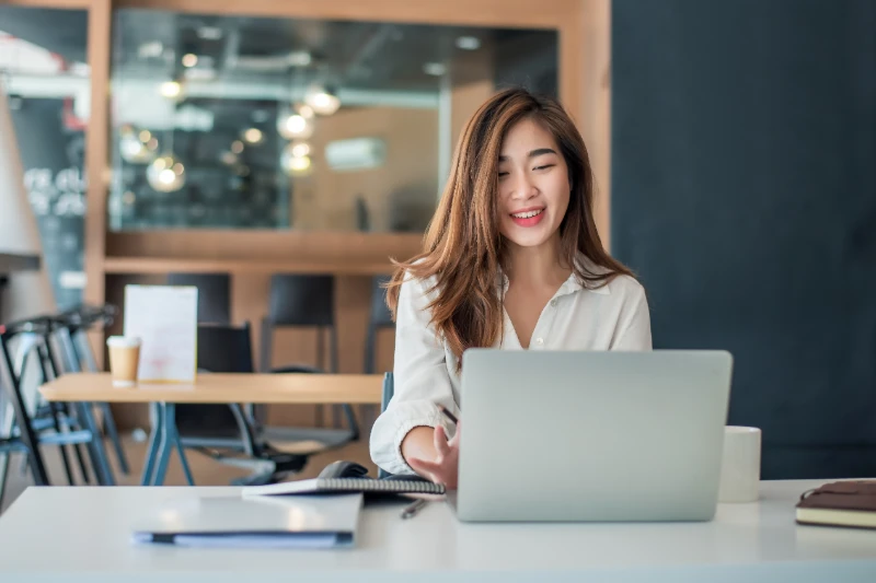 Charming asian businesswoman working on a laptop